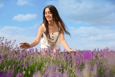 Photo of Young woman in lavender field on summer day