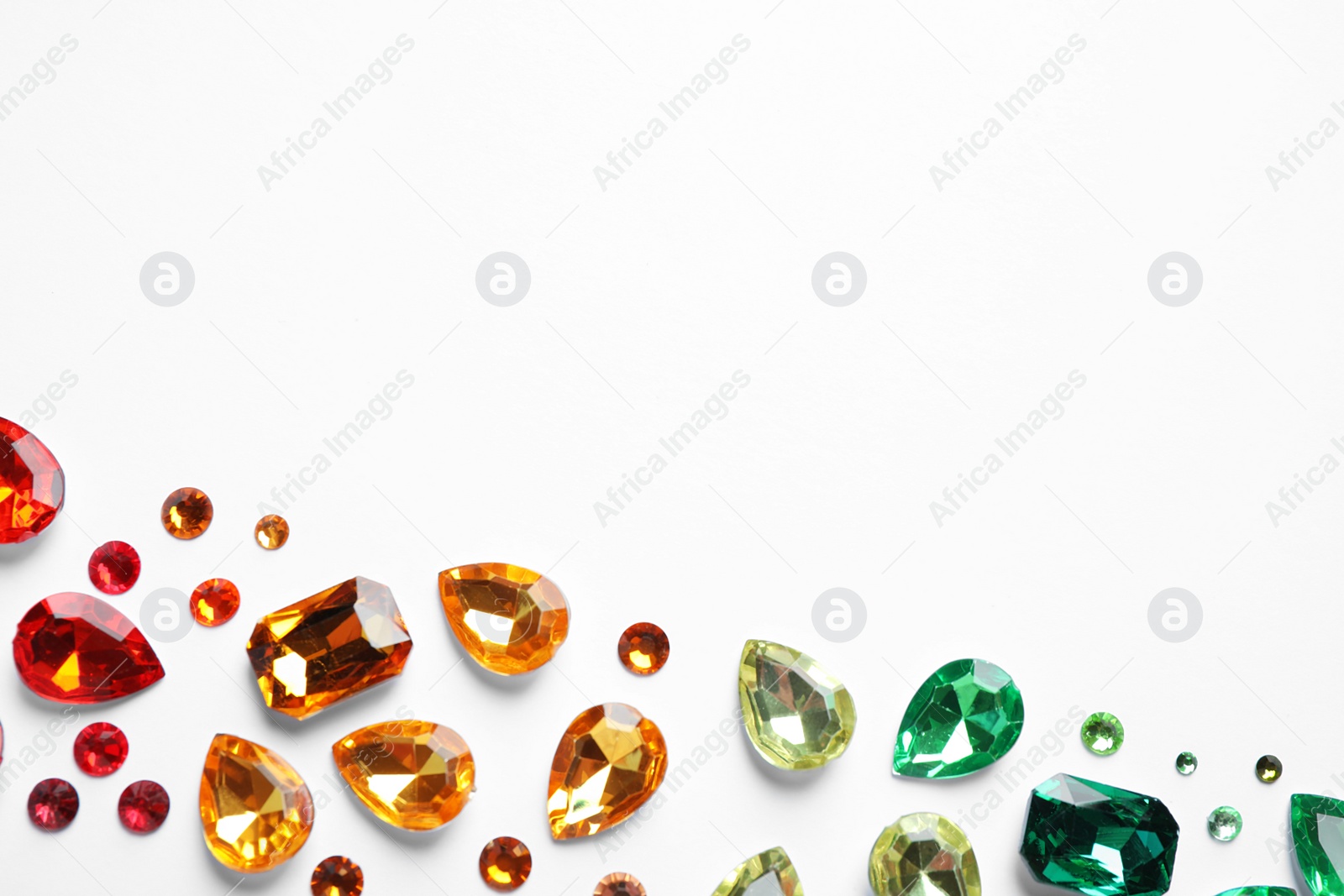 Photo of Different beautiful gemstones on white background, top view