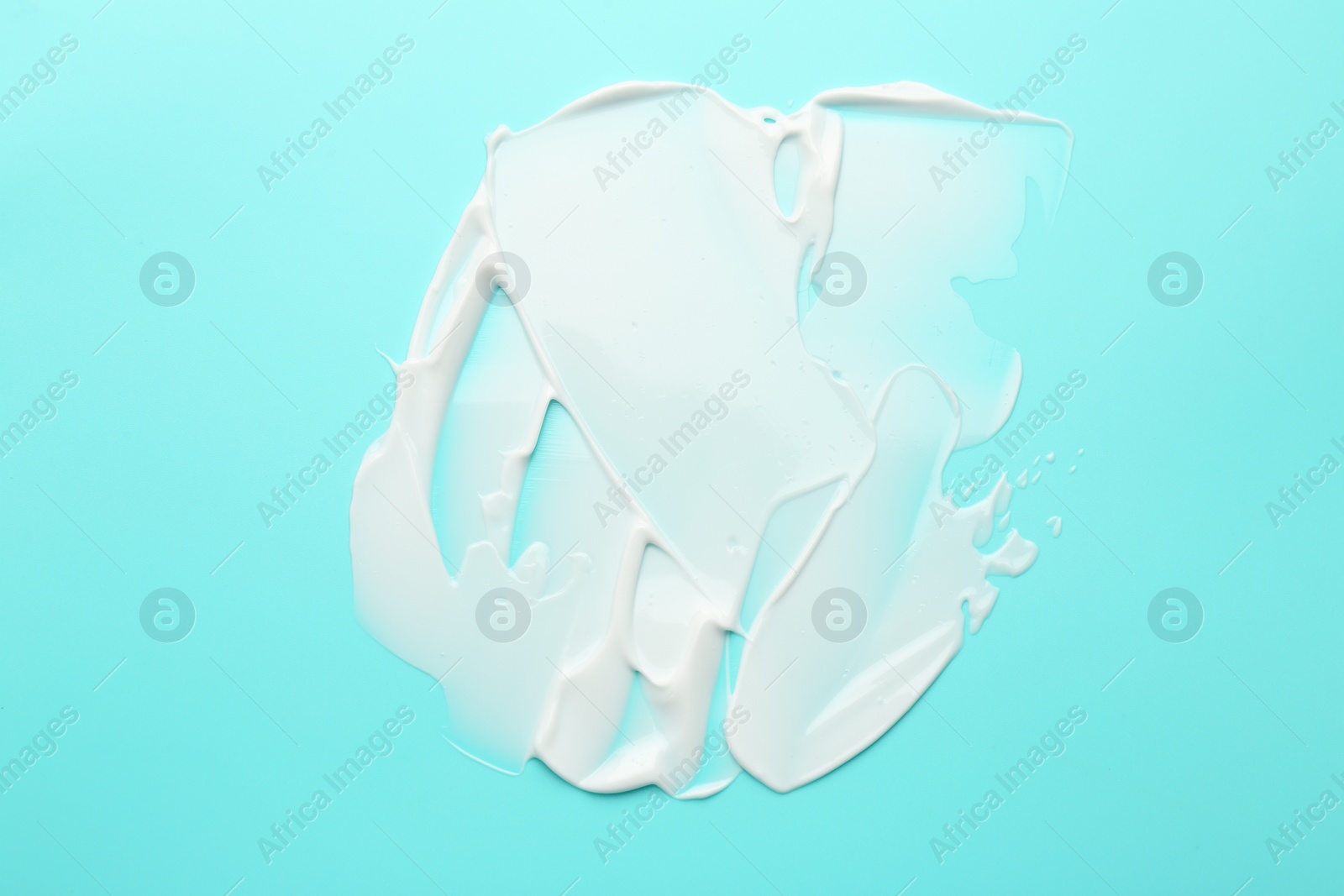 Photo of Face cream on light blue background, top view