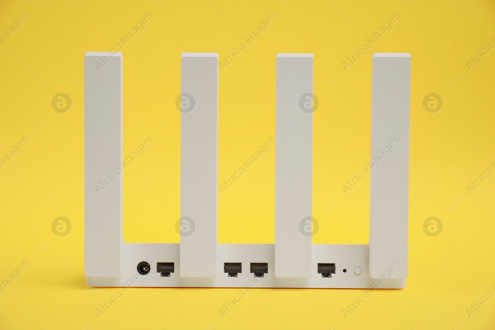 Photo of One modern Wi-Fi router on yellow background