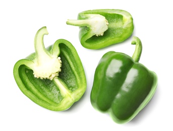 Whole and cut green bell peppers on white background, top view