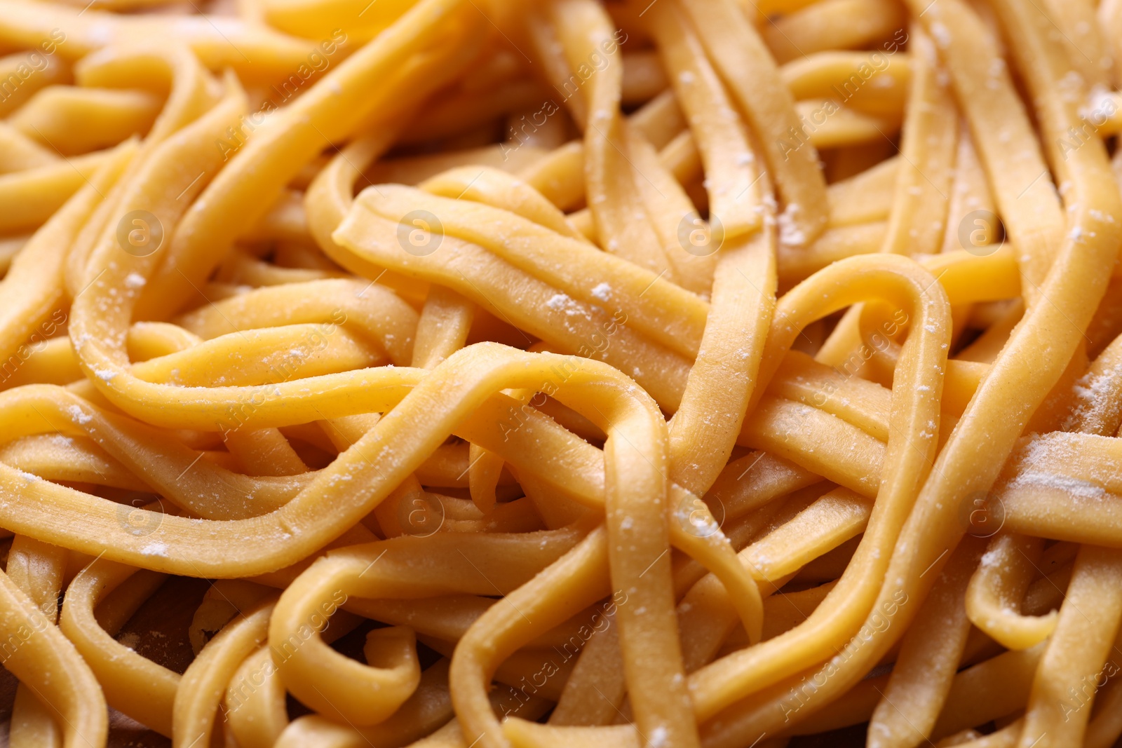 Photo of Raw homemade pasta as background, closeup view