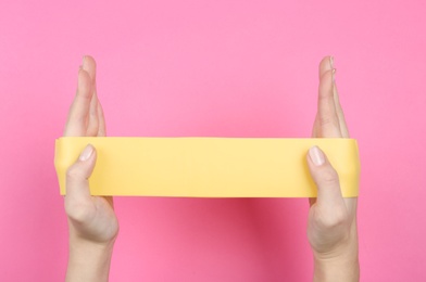 Photo of Woman with fitness elastic band on pink background, closeup