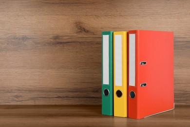 Photo of Office folders on wooden table, space for text