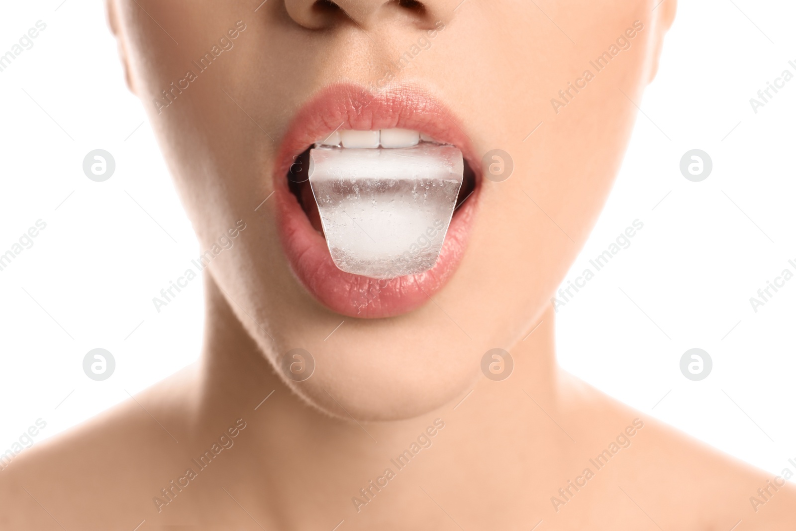 Photo of Young woman holding ice cube in mouth on white background, closeup