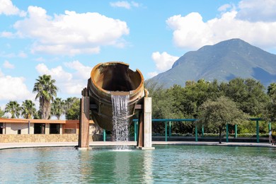 Photo of Monterrey, Mexico - September 11, 2022: Fuente de Crisol (Melting Pot Fountain) and beautiful mountains in Parque Fundidora