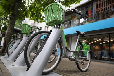 Photo of Parking rack with bicycles outdoors, low angle view