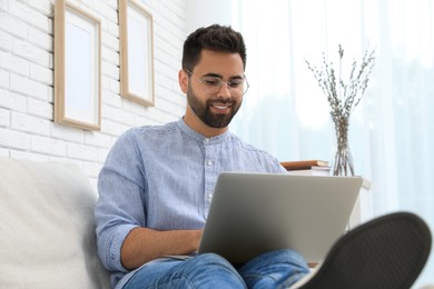 Photo of Man using laptop for online shopping at home