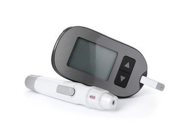 Digital glucometer and lancet pen on white background