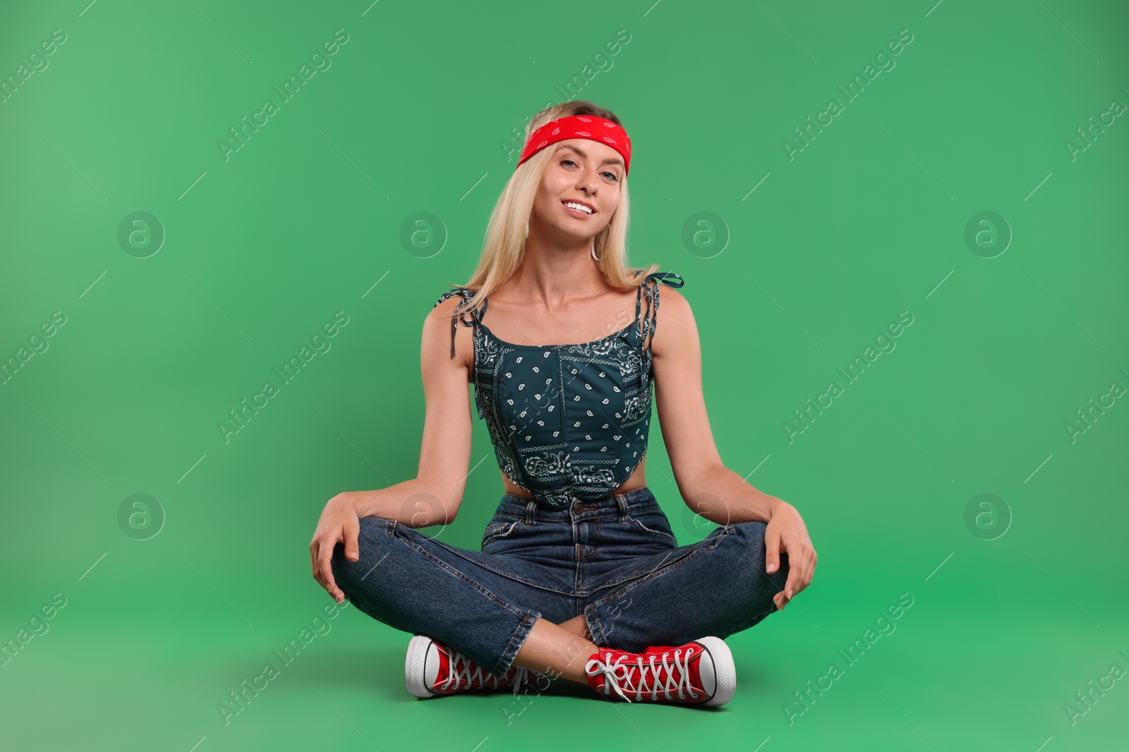 Photo of Portrait of happy hippie woman on green background