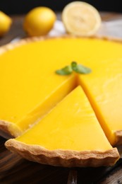 Photo of Delicious homemade lemon pie on wooden table, closeup