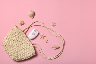 Photo of Beach bag, epilator and seashells on pink background, flat lay. Space for text