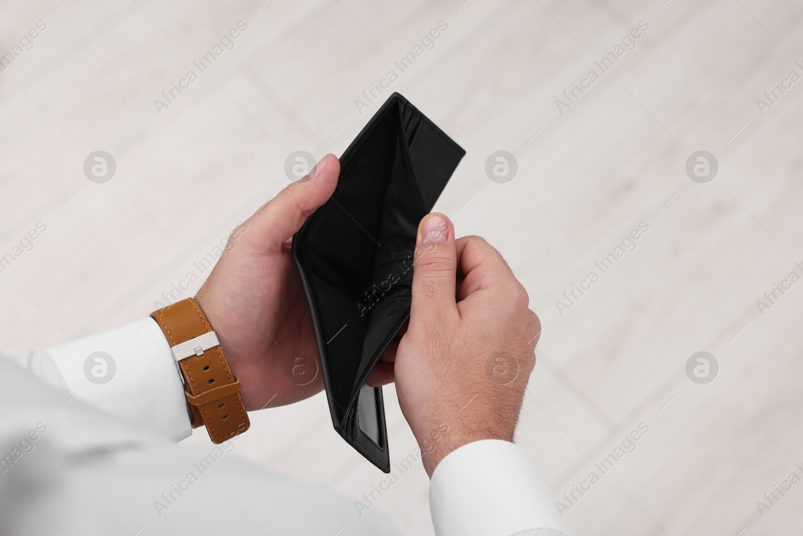 Photo of Man with empty wallet indoors, top view