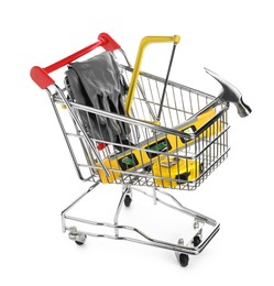 Photo of Small shopping cart with set of construction tools and gloves isolated on white