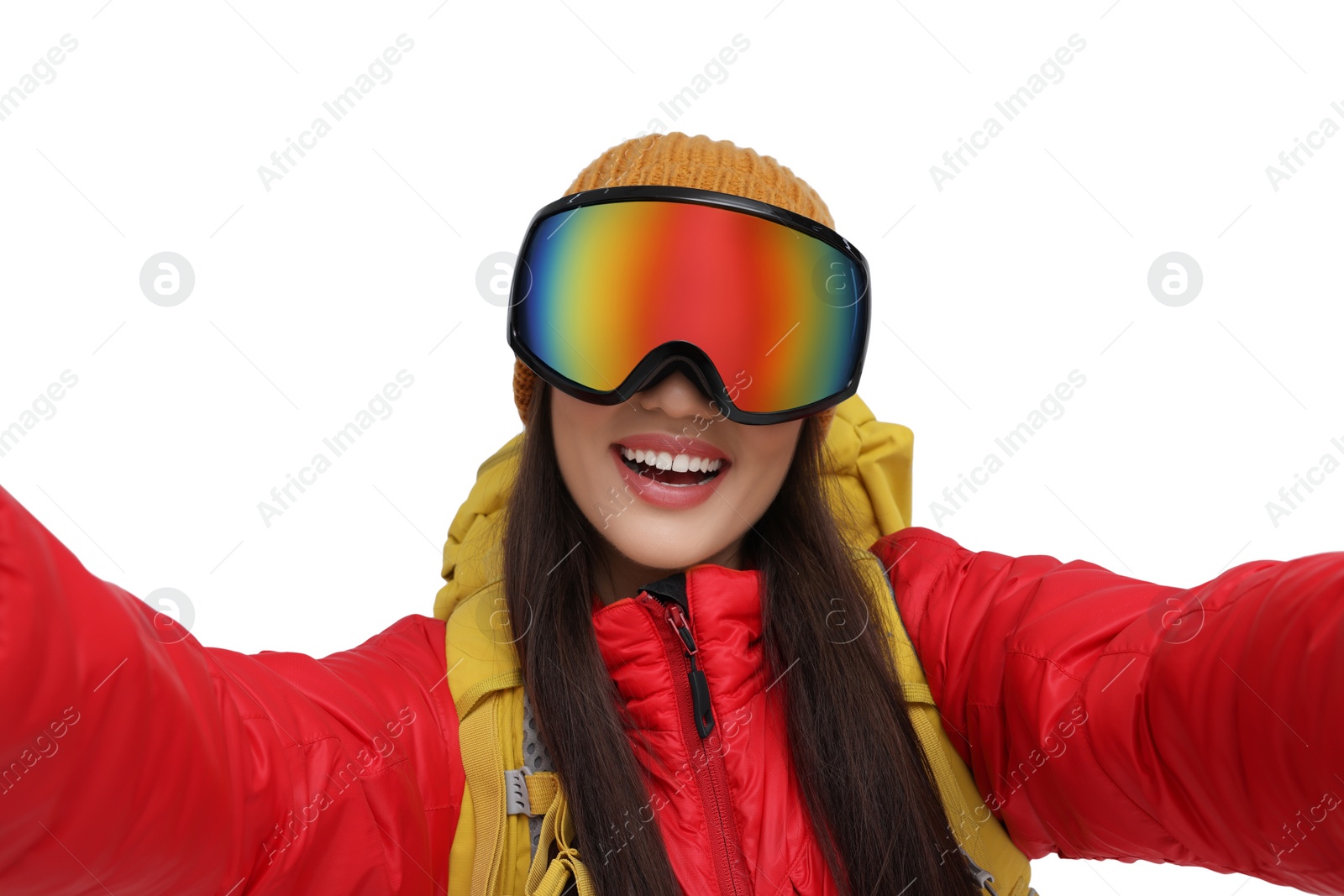 Photo of Smiling woman in ski goggles taking selfie on white background