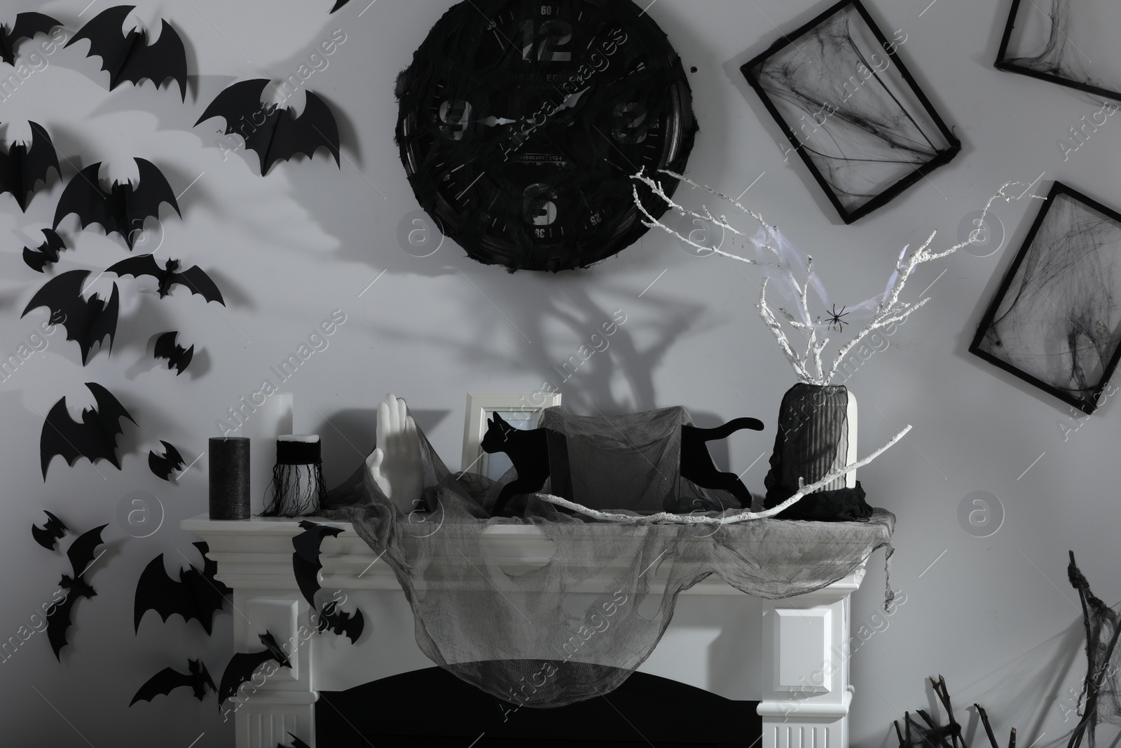 Photo of Stylish room with fireplace decorated for Halloween