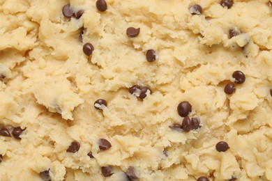 Raw dough for chocolate chip cookies as background, top view