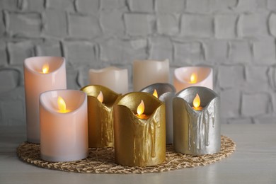 Photo of Decorative LED candles on white wooden table