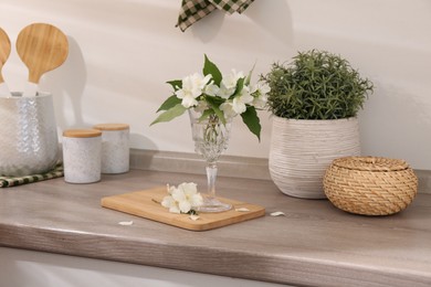 Beautiful jasmine flowers on wooden table indoors