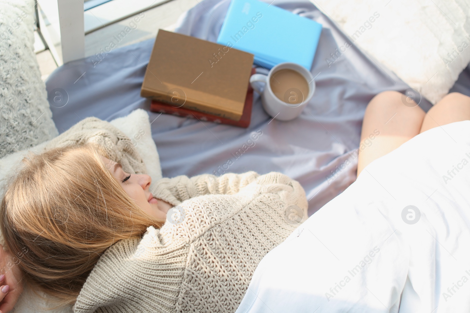 Photo of Beautiful young woman sleeping at home, top view. Winter atmosphere