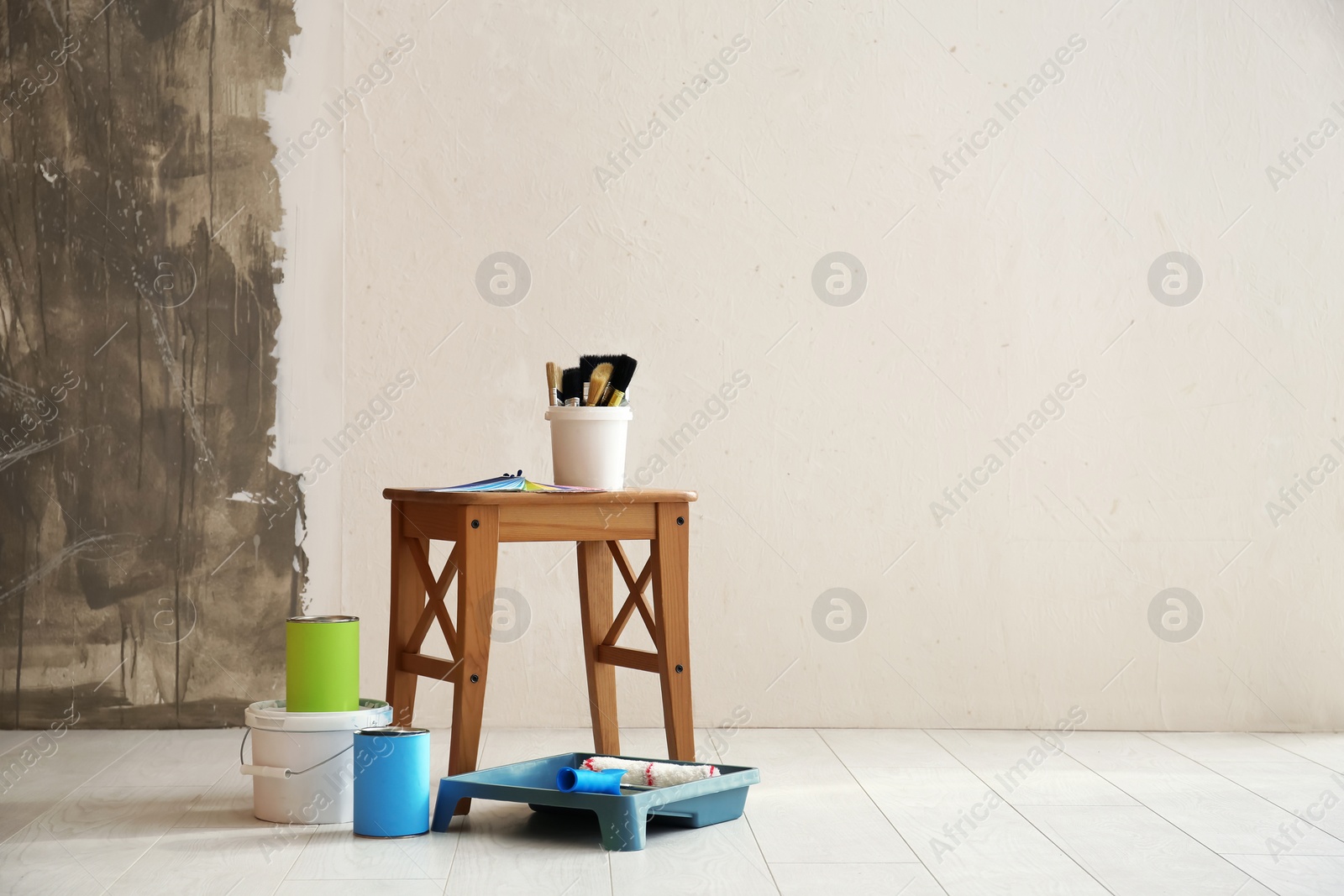 Photo of Paint and decorator's tools in light room