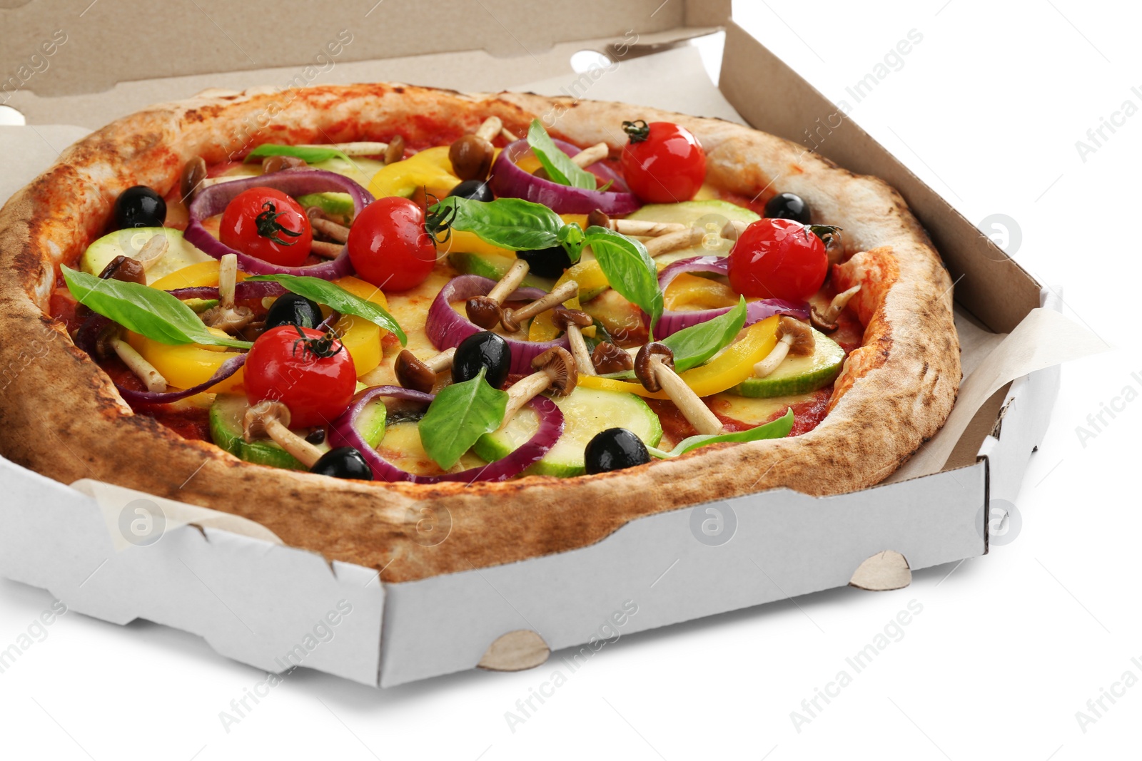 Photo of Delicious vegetable pizza in cardboard box on white background, closeup