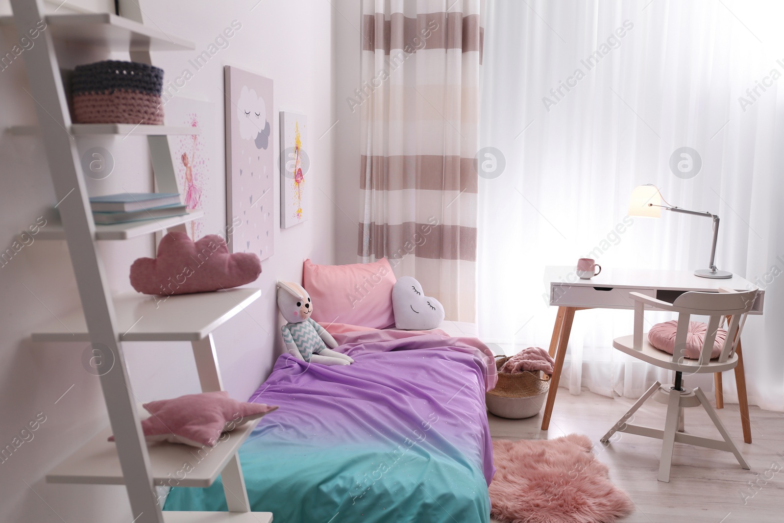 Photo of Comfortable bed with pink linens in children's room