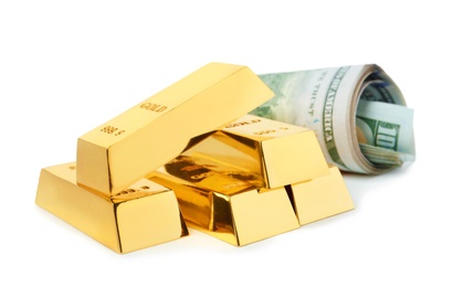 Shiny gold bars and dollar bills on white background