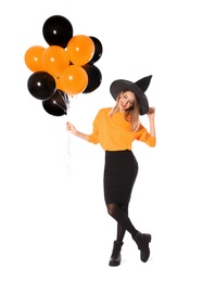 Photo of Beautiful woman wearing witch costume with balloons for Halloween party on white background