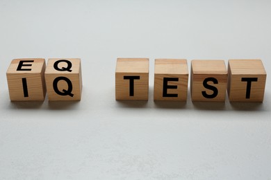 Photo of Cubes with text IQ Test on light background