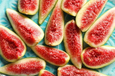 Plate with fresh ripe fig slices, top view. Tropical fruit