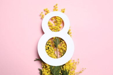 Photo of 8 March greeting card design with yellow mimosa flowers on pink background, top view. Happy International Women's Day