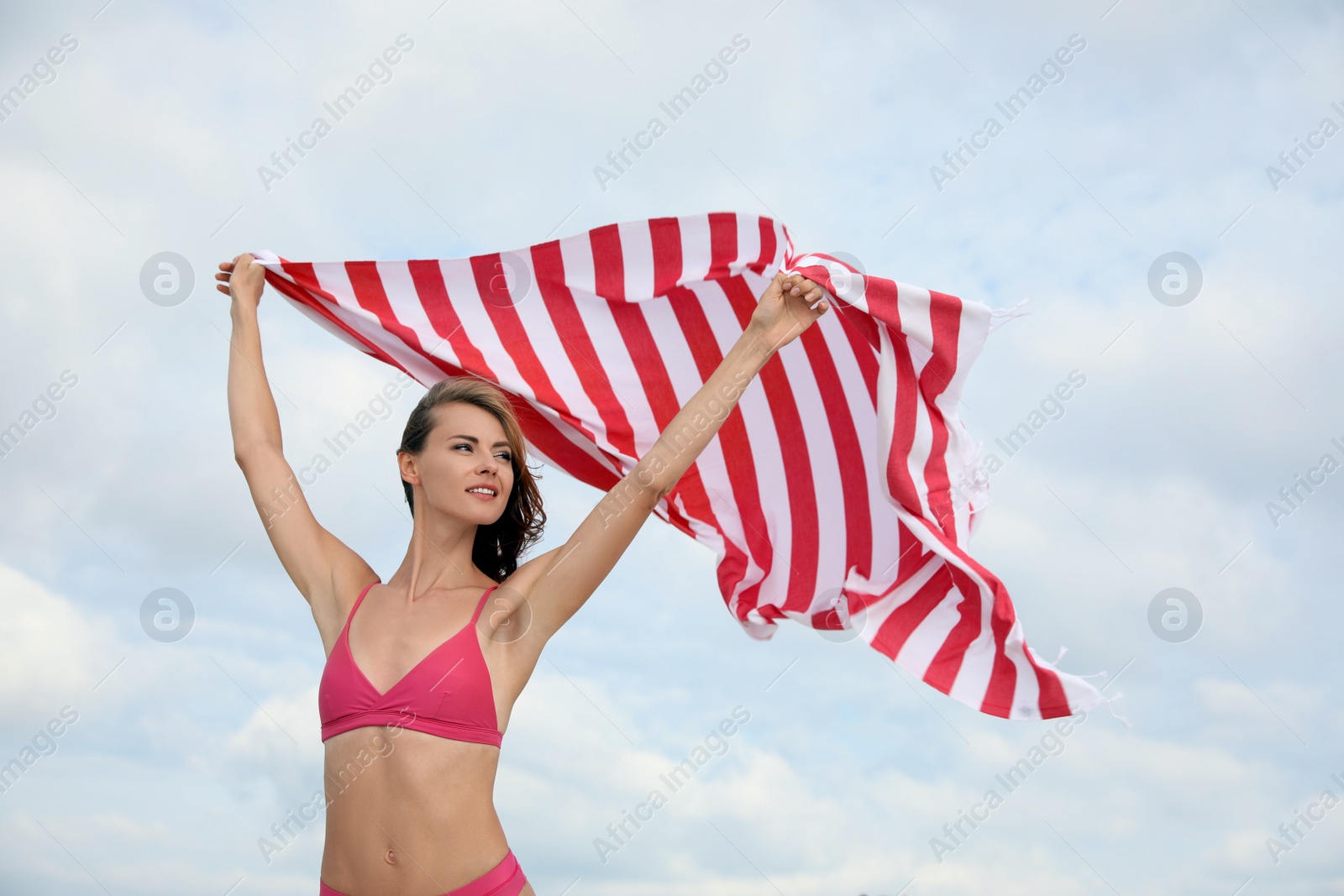 Photo of Beautiful woman with beach towel against sky