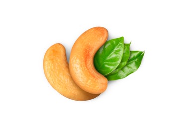 Image of Tasty cashew nuts and fresh green leaves on white background , top view