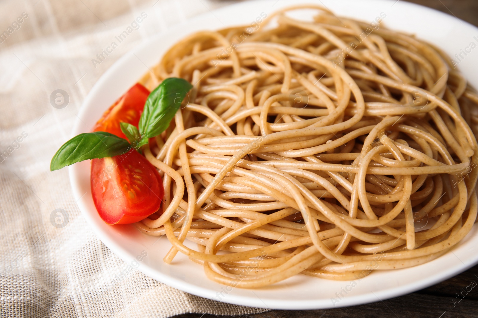 Photo of Plate of tasty buckwheat noodles on table, closeup