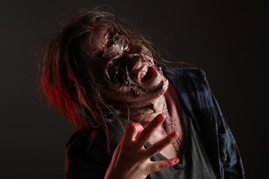 Scary zombie on dark background. Halloween monster