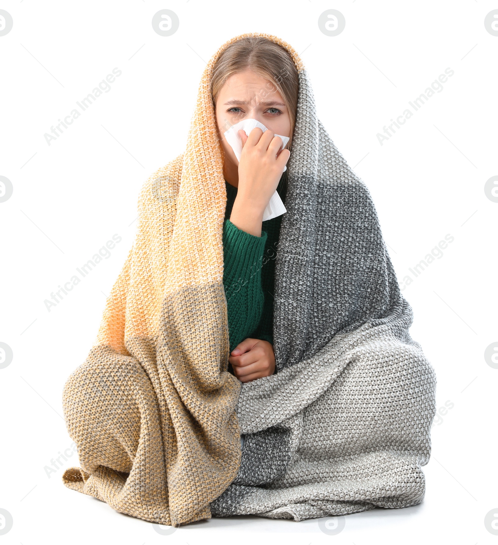 Photo of Young woman wrapped in warm blanket suffering from cold on white background