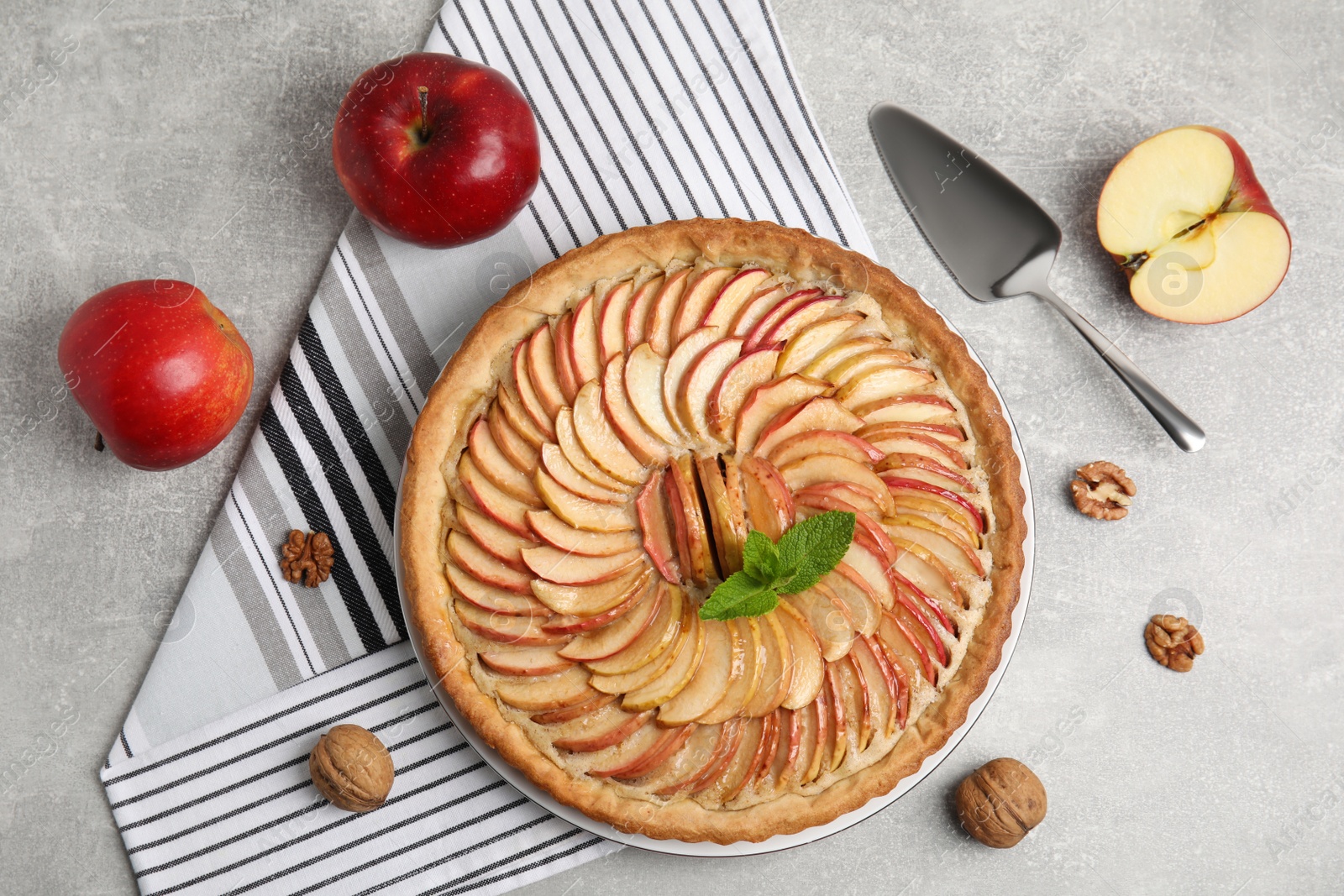 Photo of Flat lay composition with delicious homemade apple tart on grey table