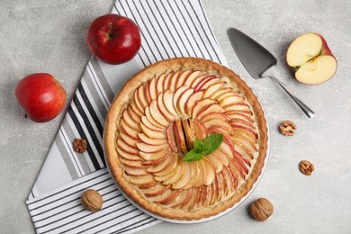 Flat lay composition with delicious homemade apple tart on grey table