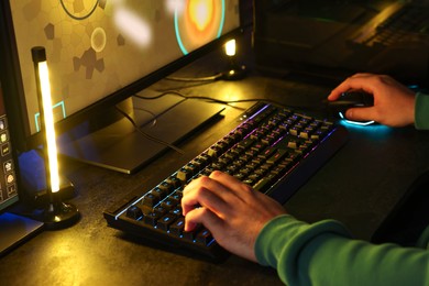 Photo of Man playing video games on computer indoors, closeup