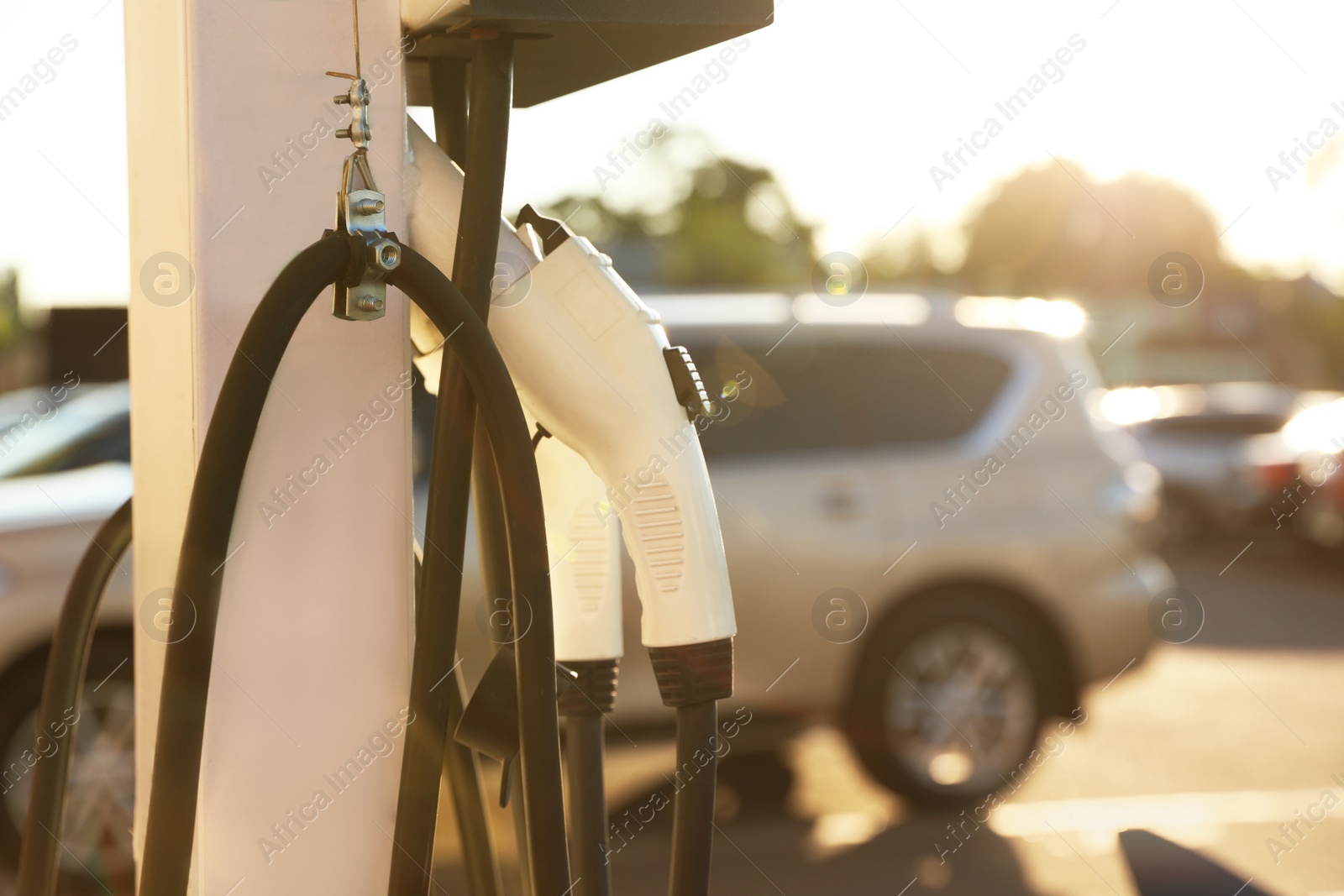 Photo of Electric vehicle charging station outdoors, closeup. Space for text