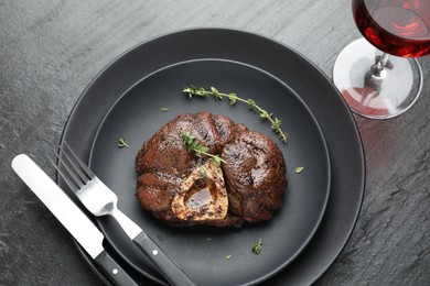 Tasty grilled beef meat served on black table, flat lay