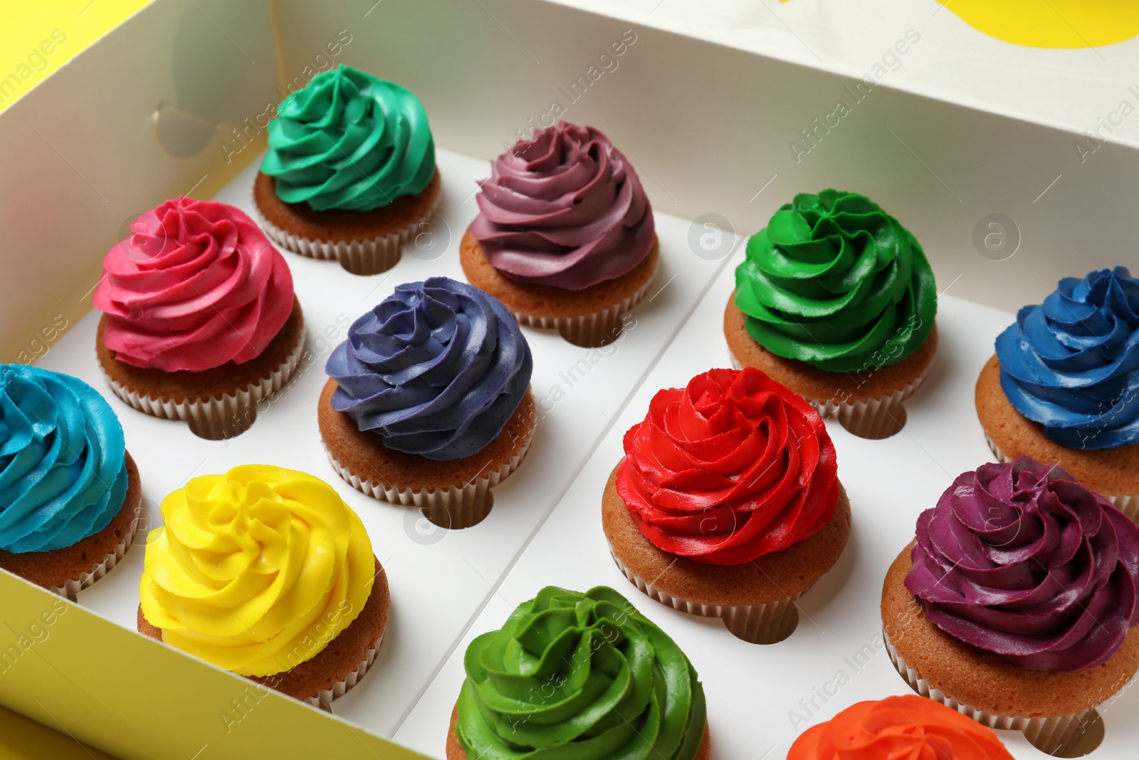 Photo of Different cupcakes with cream in box, closeup