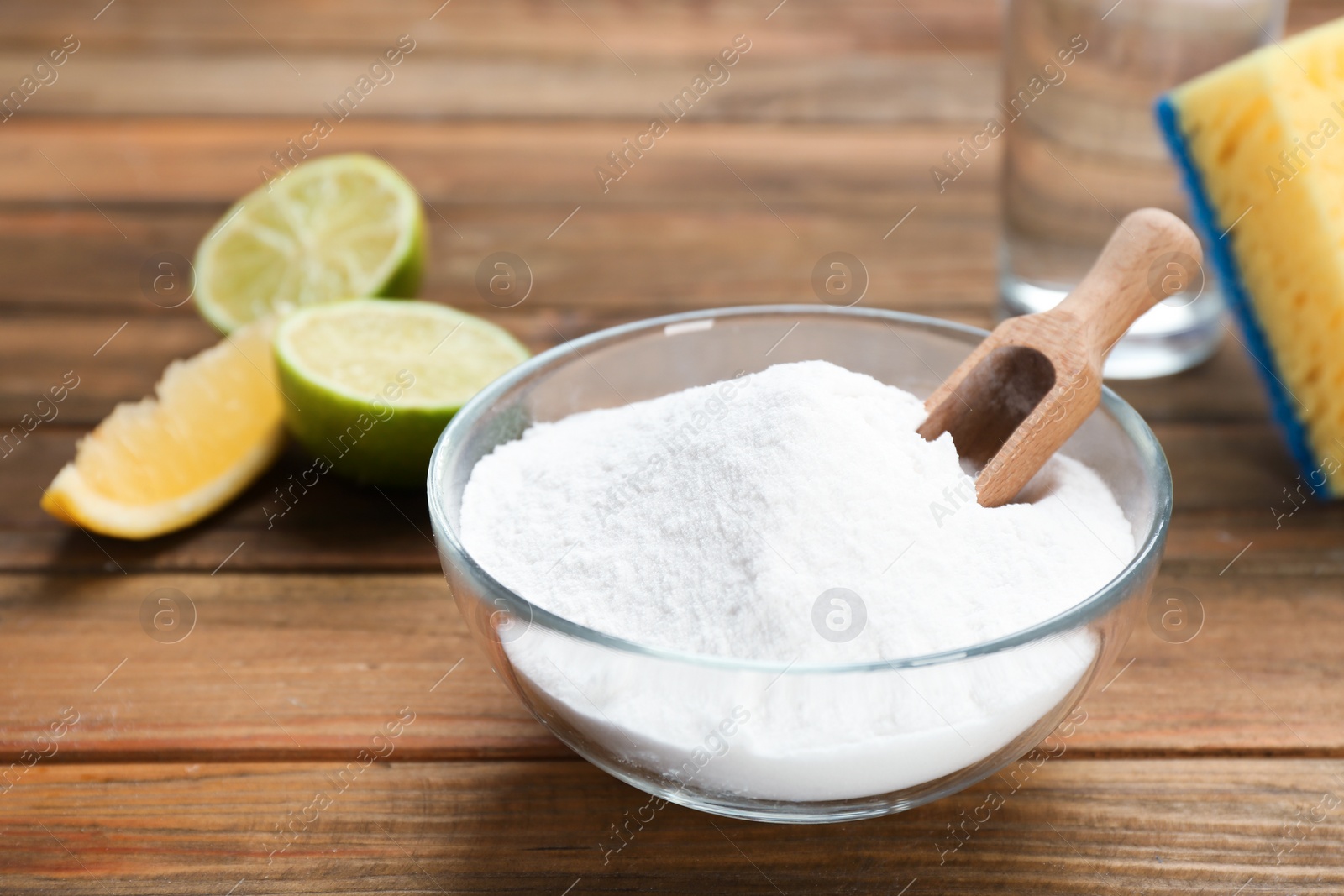 Photo of Bowl with baking soda on wooden table