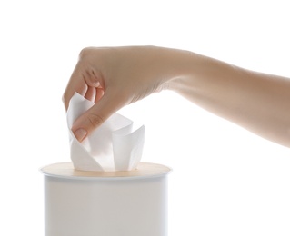 Woman taking paper tissue from holder on white background, closeup