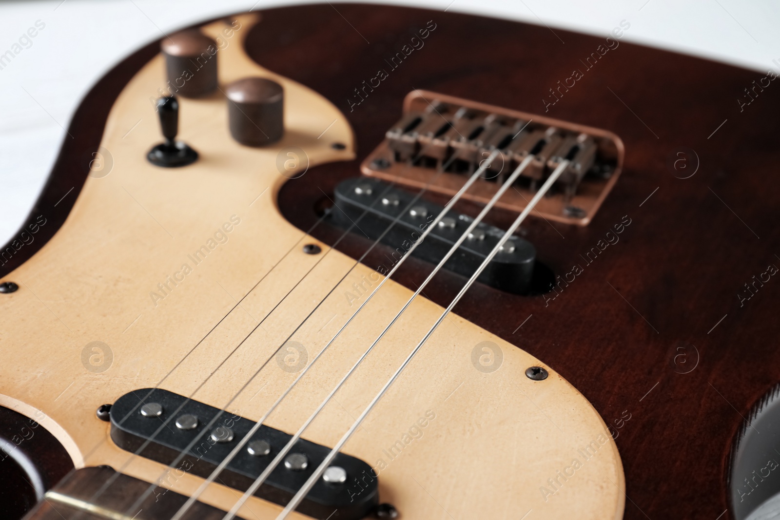 Photo of Modern electric guitar, view on body with strings. Musical instrument