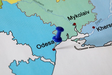 Map of Ukraine with blue push pin placed on Odesa, closeup