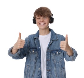 Photo of Teenage boy listening to music with headphones on white background