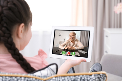 Distance learning, studying at home. Girl having online school lesson during quarantine and lockdown due to Covid-19 pandemic