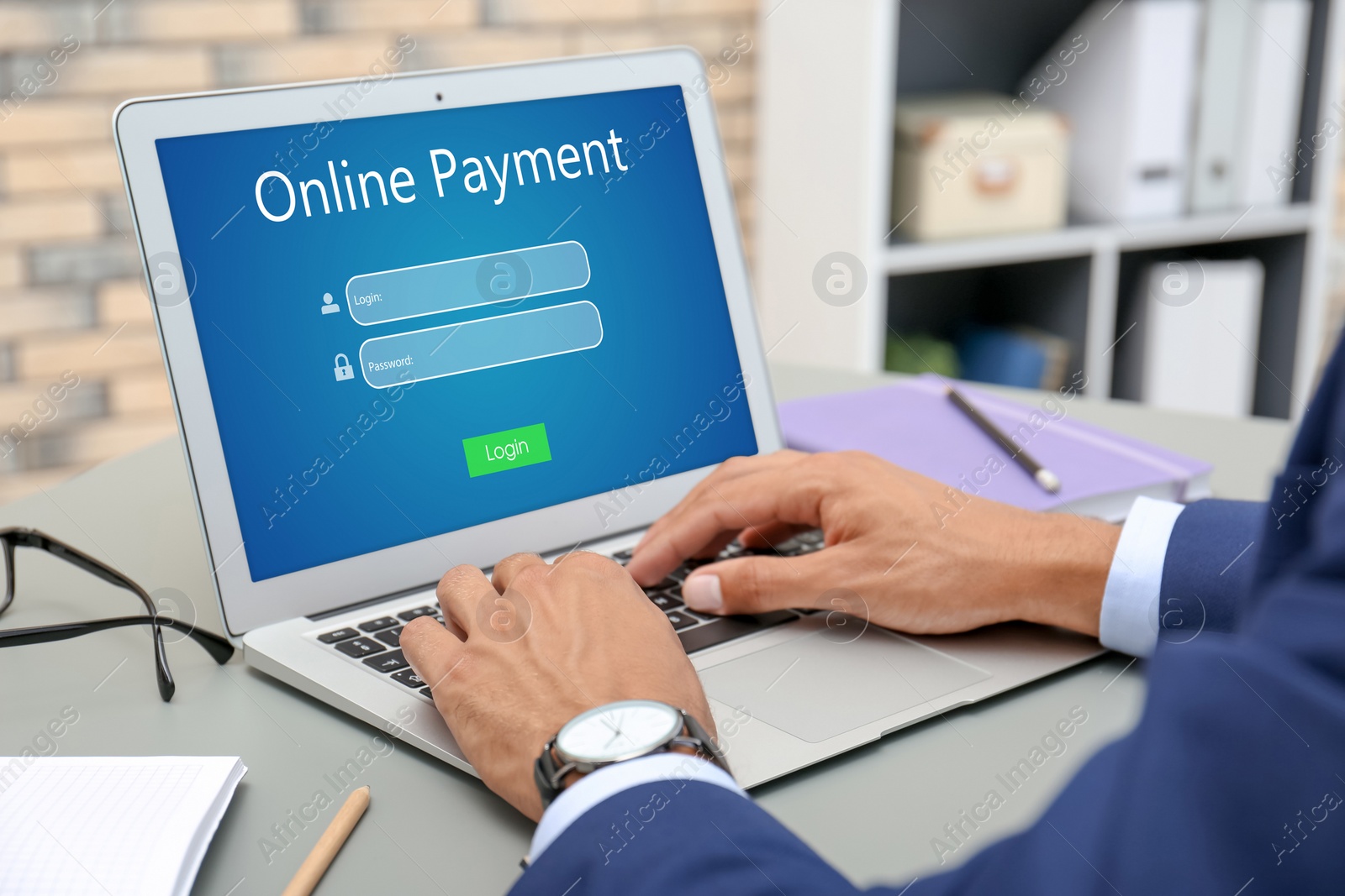 Image of Man using laptop for online payment at grey table, closeup